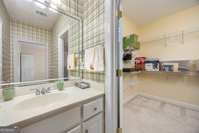 bathroom featuring a textured ceiling and vanity