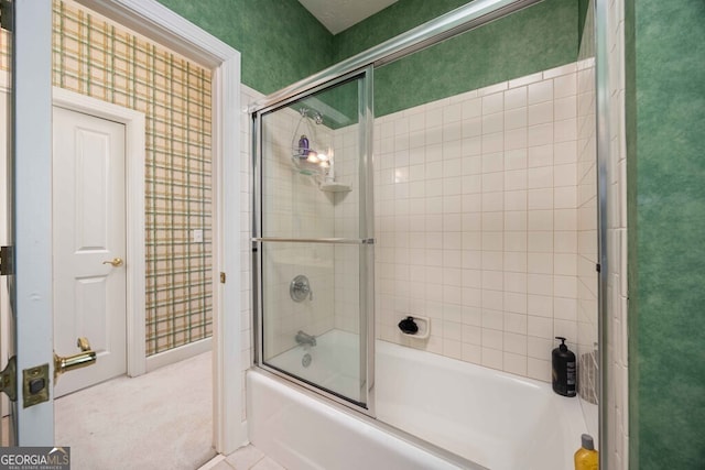 bathroom featuring combined bath / shower with glass door