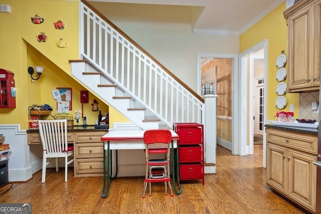 interior space with wood-type flooring, decorative backsplash, and crown molding