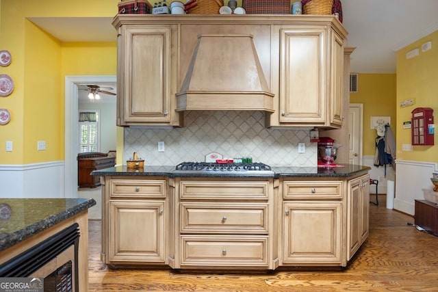 kitchen featuring dark stone countertops, appliances with stainless steel finishes, tasteful backsplash, and custom exhaust hood