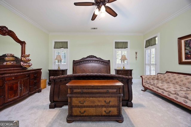 carpeted bedroom featuring ceiling fan and crown molding