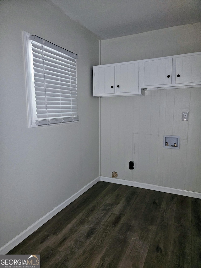 clothes washing area with washer hookup, cabinets, and dark hardwood / wood-style floors