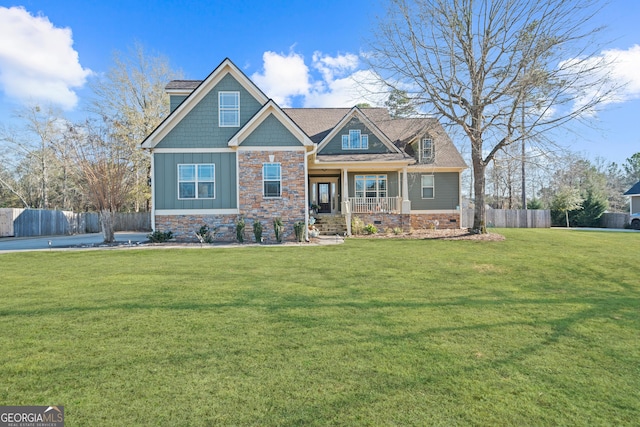 craftsman house with covered porch and a front lawn