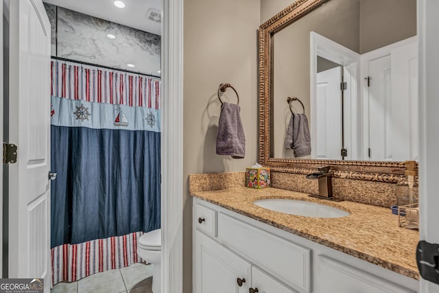 bathroom with tile patterned floors, toilet, curtained shower, and vanity