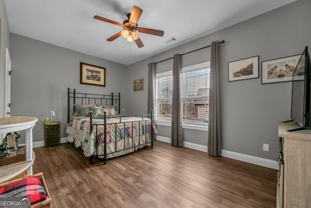 bedroom featuring dark hardwood / wood-style floors and ceiling fan