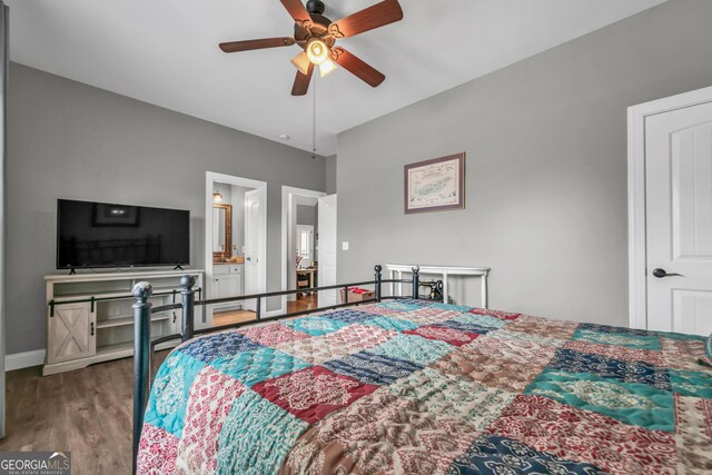 bedroom with ensuite bathroom, wood-type flooring, and ceiling fan