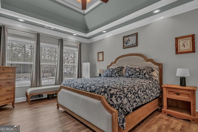 bedroom with crown molding, ceiling fan, and hardwood / wood-style flooring