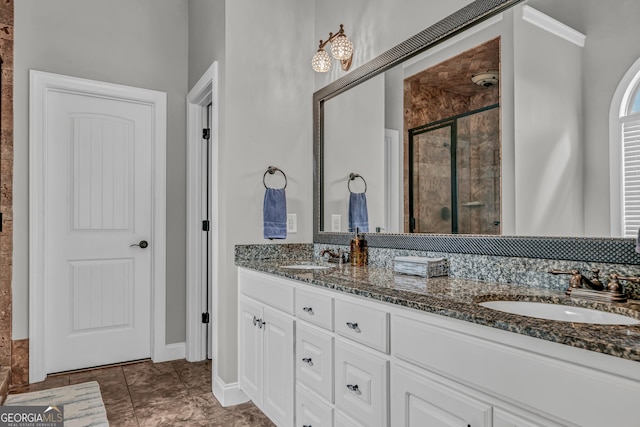 bathroom featuring tile patterned floors, vanity, and a shower with door