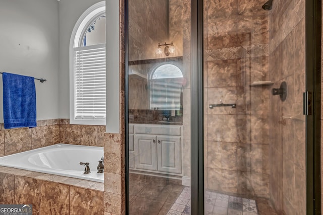 bathroom featuring a healthy amount of sunlight and separate shower and tub