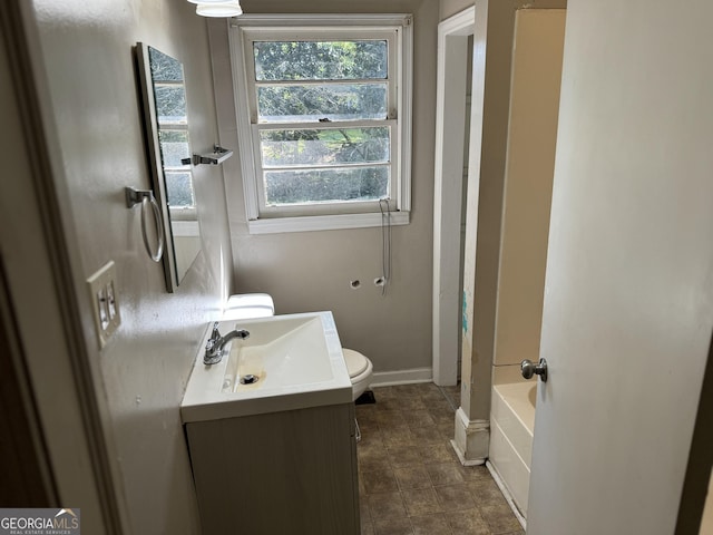 full bathroom featuring toilet, washtub / shower combination, and vanity