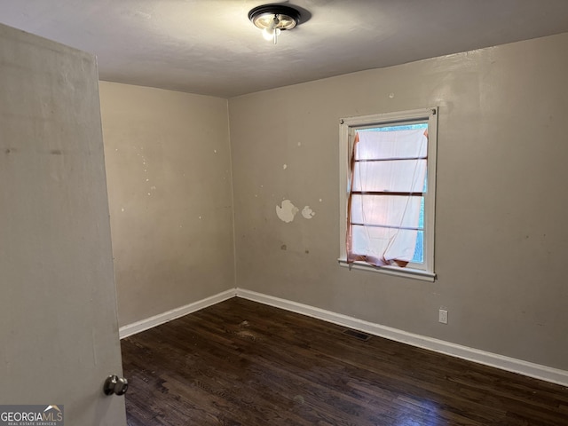 unfurnished room featuring dark hardwood / wood-style floors