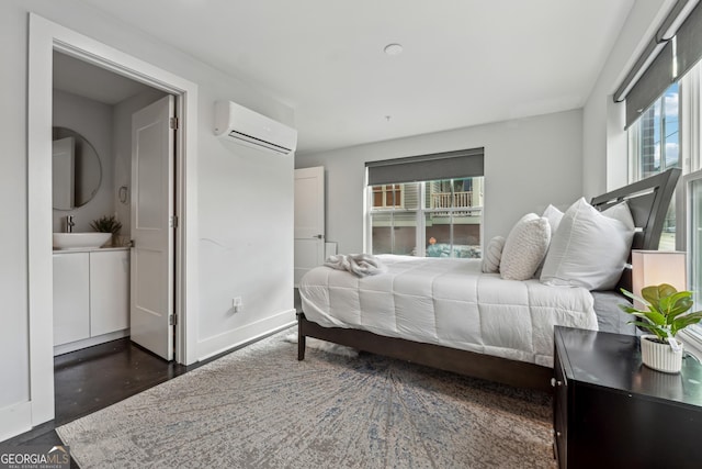 bedroom featuring sink and an AC wall unit