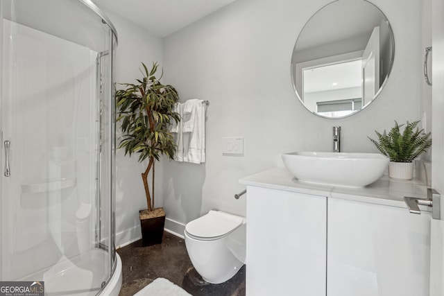 full bathroom with toilet, a shower stall, baseboards, and vanity