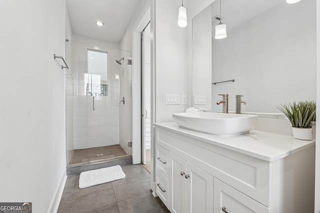 bathroom with a stall shower, tile patterned flooring, baseboards, and vanity