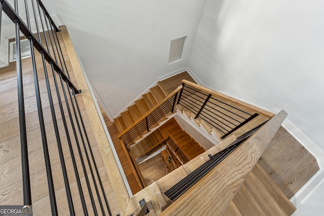 stairs featuring wood finished floors