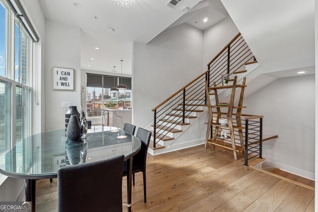 kitchen featuring white cabinetry, appliances with stainless steel finishes, pendant lighting, and an island with sink