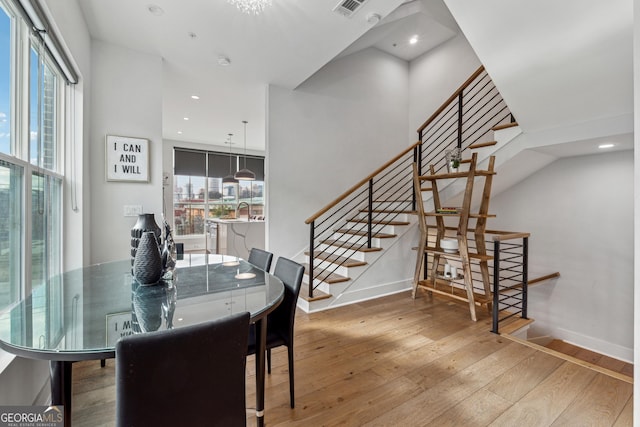 dining area featuring a wealth of natural light, visible vents, baseboards, and wood finished floors