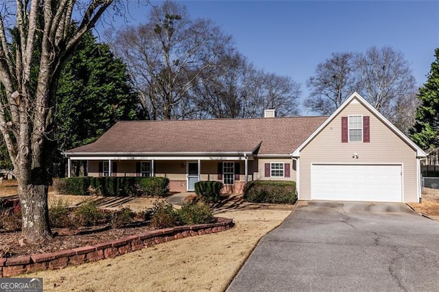 view of front of home featuring a porch and a garage