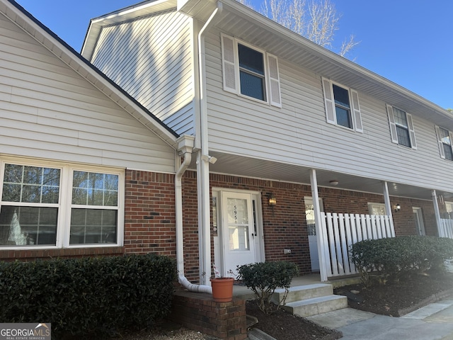 view of front of property featuring covered porch and brick siding