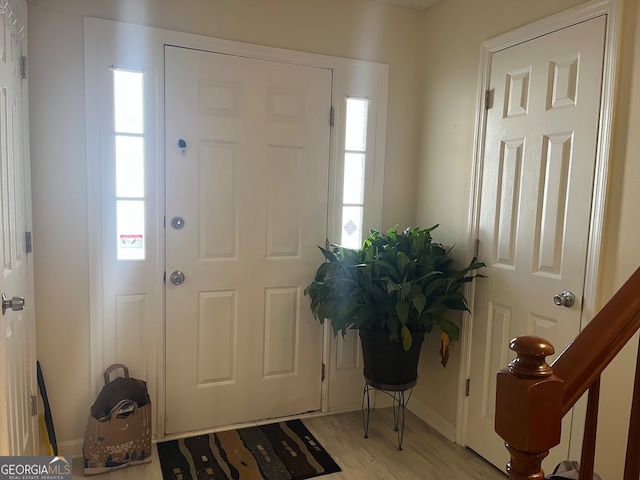 entrance foyer with light wood-style flooring and stairway