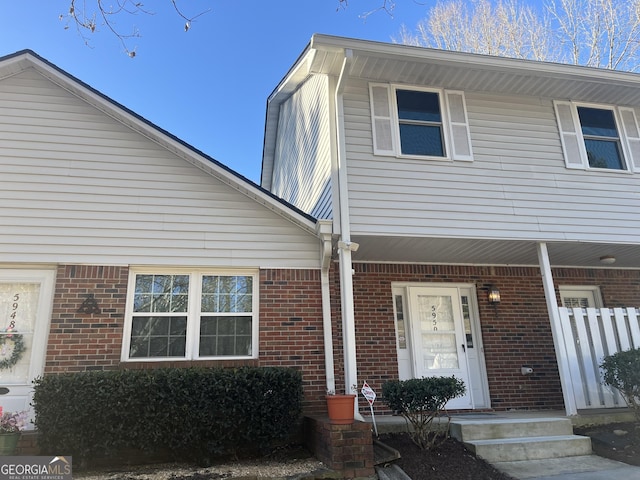 view of front of house with covered porch and brick siding