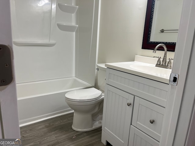 full bathroom featuring toilet, shower / bathing tub combination, wood finished floors, and vanity