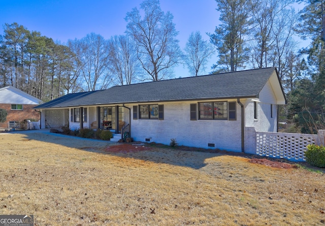 ranch-style home with covered porch and a front lawn