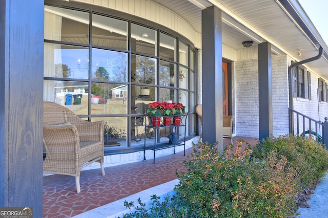 view of exterior entry featuring covered porch