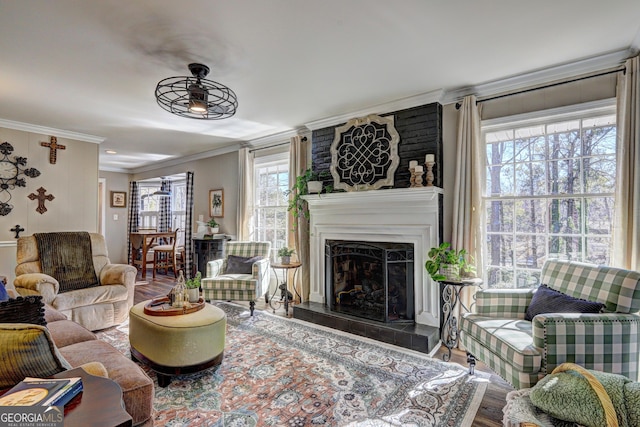 living room featuring hardwood / wood-style floors, crown molding, and a healthy amount of sunlight