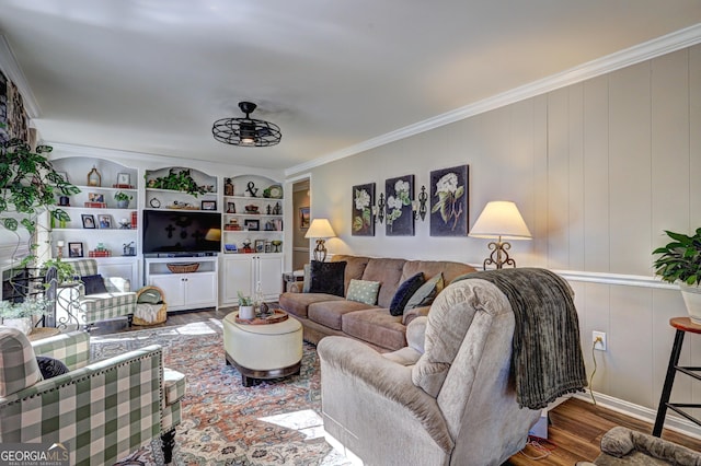 living room featuring ceiling fan, crown molding, built in features, and hardwood / wood-style floors