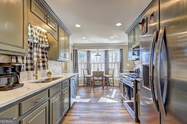 kitchen featuring crown molding, appliances with stainless steel finishes, decorative backsplash, and sink