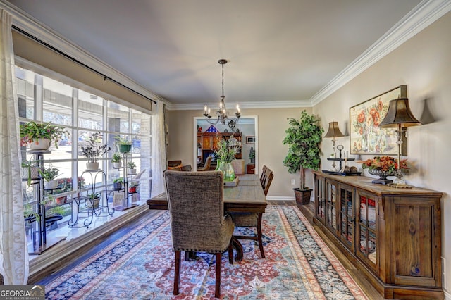 dining area with crown molding, a chandelier, and hardwood / wood-style floors