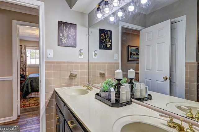 bathroom with vanity, wood-type flooring, and tile walls