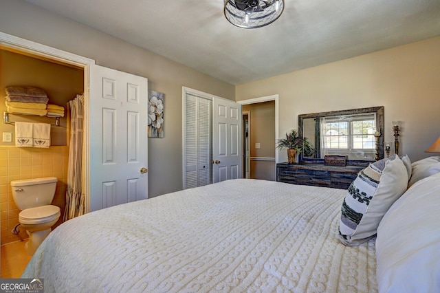 bedroom featuring tile walls