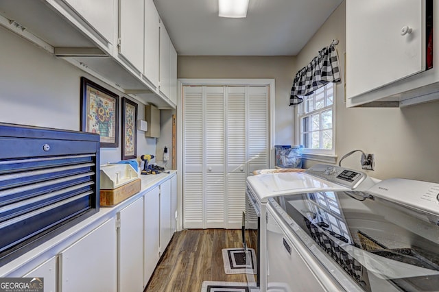 kitchen featuring dark hardwood / wood-style floors, washer and dryer, and white cabinets