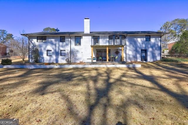 back of property with a patio area and a balcony