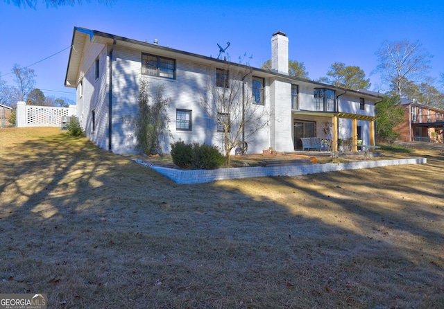 rear view of property featuring a balcony