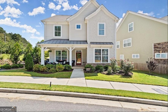 view of front of home featuring a front yard and covered porch