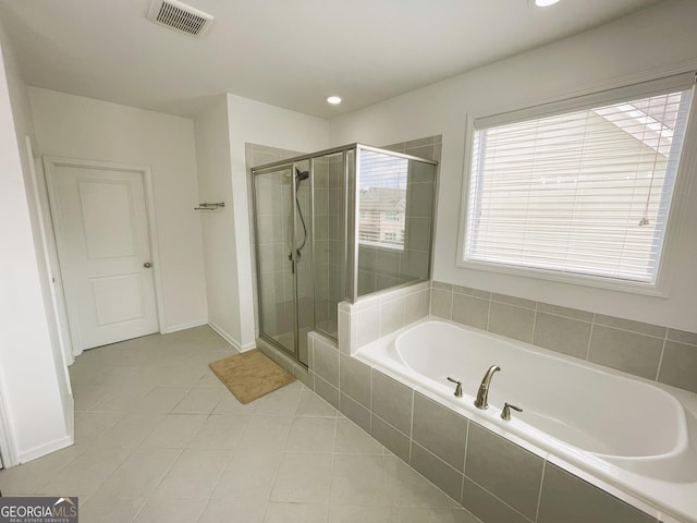 bathroom featuring tile patterned flooring and shower with separate bathtub