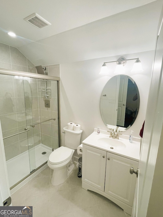 bathroom with toilet, lofted ceiling, an enclosed shower, and tile patterned flooring