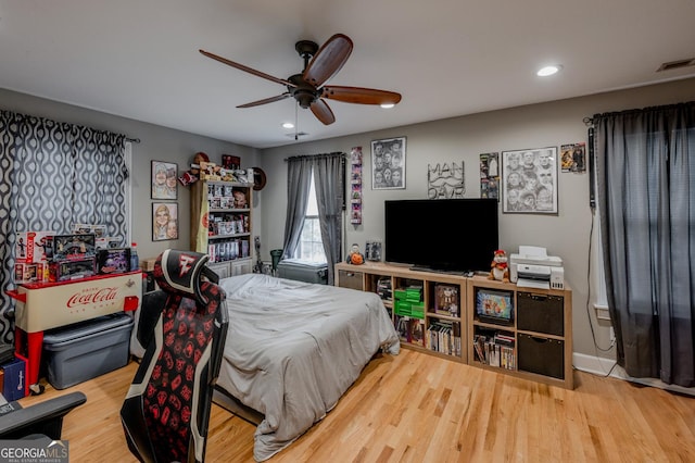 bedroom with ceiling fan and hardwood / wood-style floors