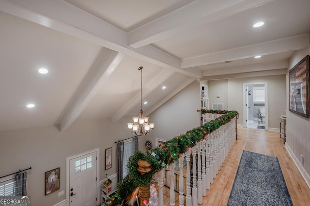 corridor featuring light hardwood / wood-style flooring, vaulted ceiling with beams, and a notable chandelier