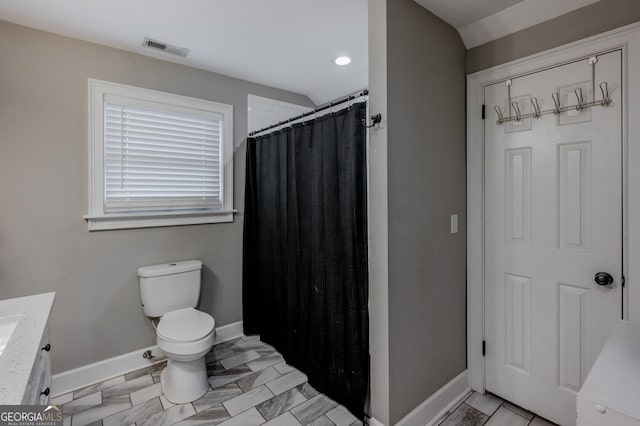 bathroom with toilet, vanity, and a shower with shower curtain