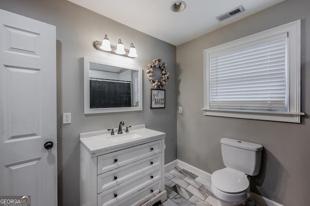 bathroom with toilet and vanity