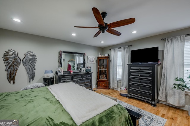 bedroom with ceiling fan and light hardwood / wood-style flooring