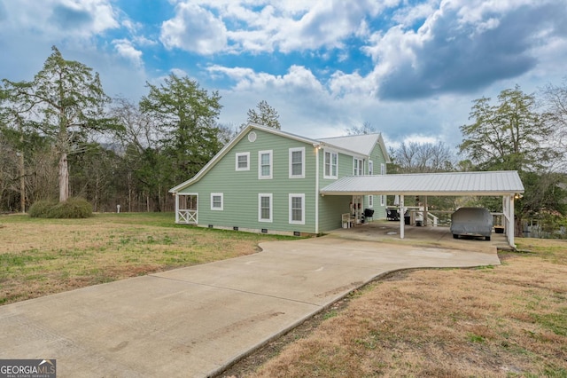 view of front of house with a front yard and a carport