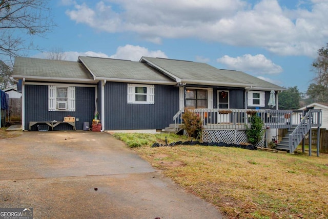 ranch-style house with covered porch and a front lawn