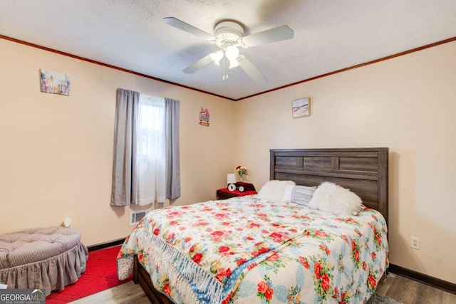 bedroom with ceiling fan, a textured ceiling, and hardwood / wood-style floors