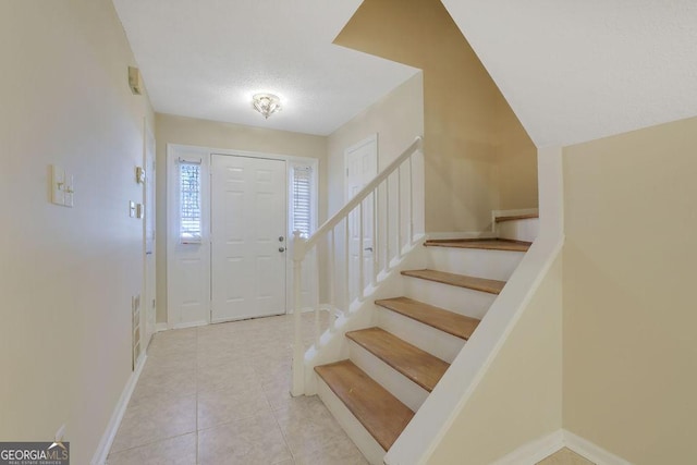 entryway featuring light tile patterned floors