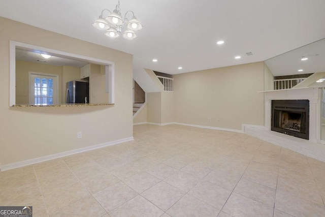 unfurnished living room with light tile patterned flooring and a chandelier